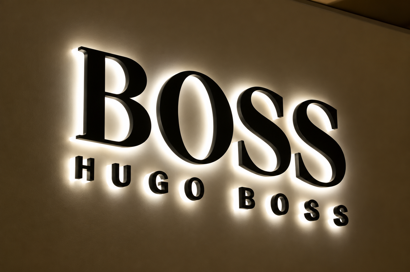 Close-up of evenly illuminated halo-lit letters on a smooth wall