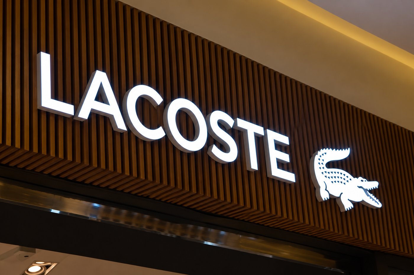 Custom face-lit business logo mounted on a dark exterior wall