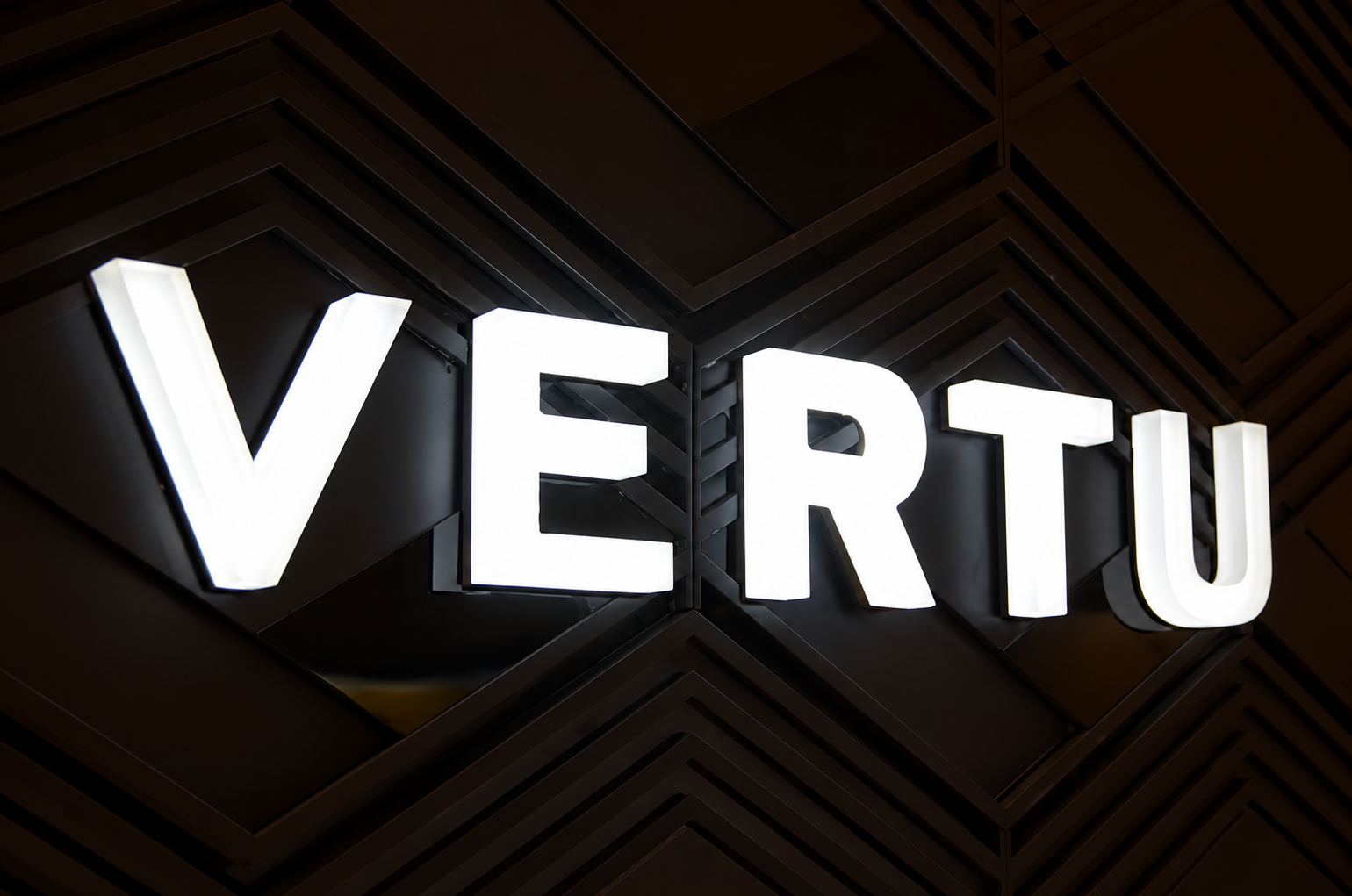Fully illuminated business letters glowing above a modern shopfront